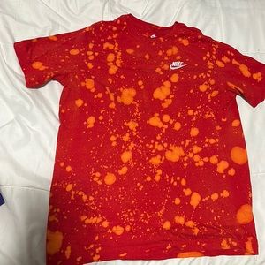 Red Nike tshirt with orange splatter
